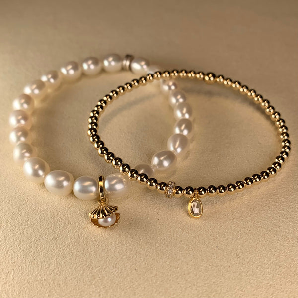 14k gold stackable bracelet with 18k gold diamond rondel and rose cut diamond charm